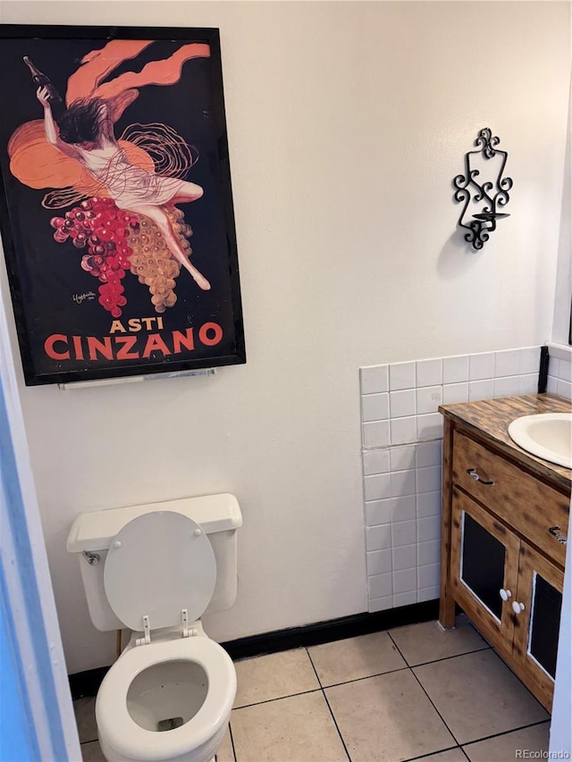 bathroom featuring toilet, tile patterned flooring, and vanity