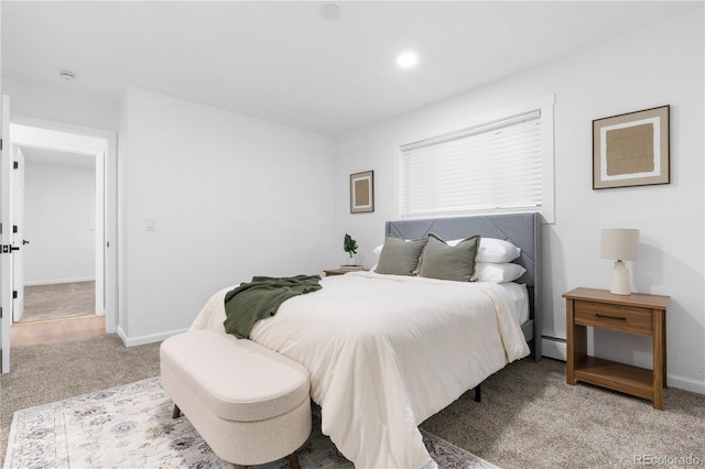 carpeted bedroom featuring baseboard heating