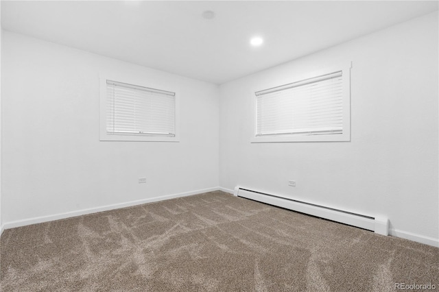 carpeted empty room with a baseboard radiator