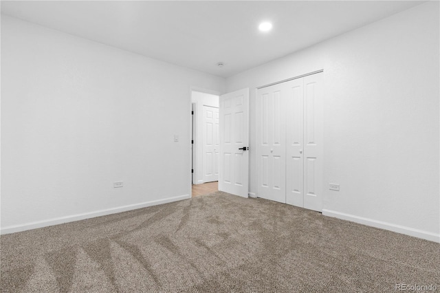 unfurnished bedroom featuring a closet and carpet