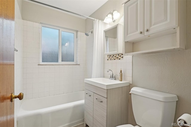 4072 Ames St, Wheat Ridge, CO 80212 - bathroom featuring toilet, shower / bathtub combination with curtain, tile walls, vanity, and tasteful backsplash