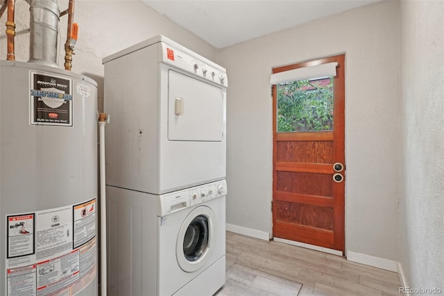 4072 Ames St, Wheat Ridge, CO 80212 - clothes washing area with gas water heater, stacked washer / dryer, light wood-style flooring, and baseboards