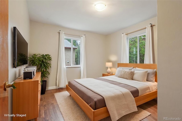 4072 Ames St, Wheat Ridge, CO 80212 - bedroom featuring multiple windows, wood finished floors, and baseboards