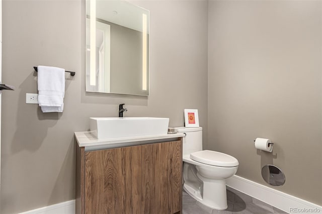 bathroom featuring tile patterned floors, toilet, and vanity