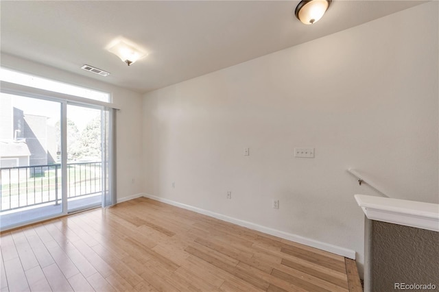 unfurnished room with visible vents, baseboards, and light wood-type flooring