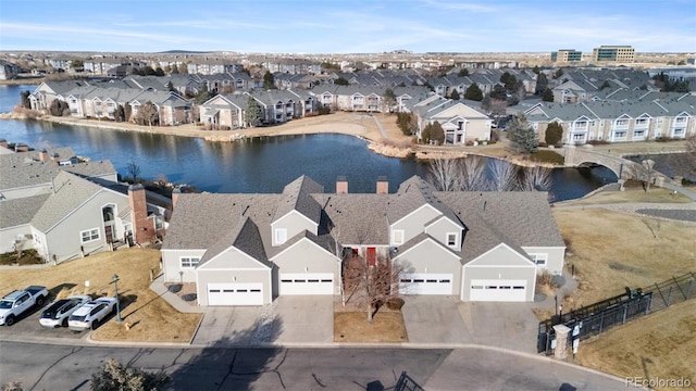 bird's eye view featuring a residential view and a water view