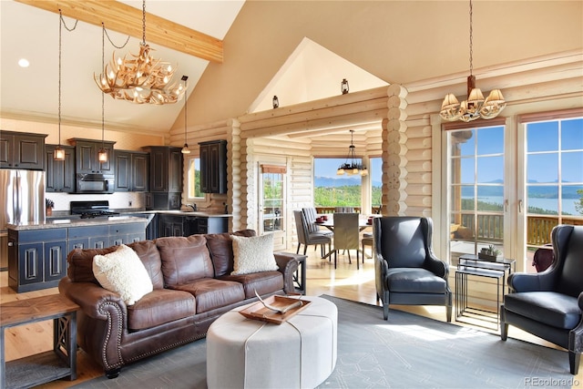 living room with a notable chandelier, beam ceiling, high vaulted ceiling, rustic walls, and a water view