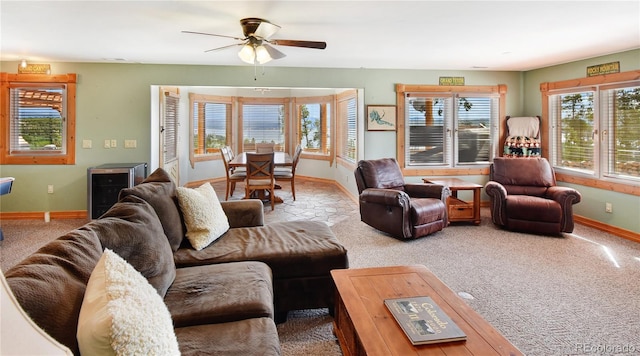 living room with carpet, beverage cooler, and baseboards