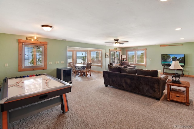 living room featuring ceiling fan and carpet flooring