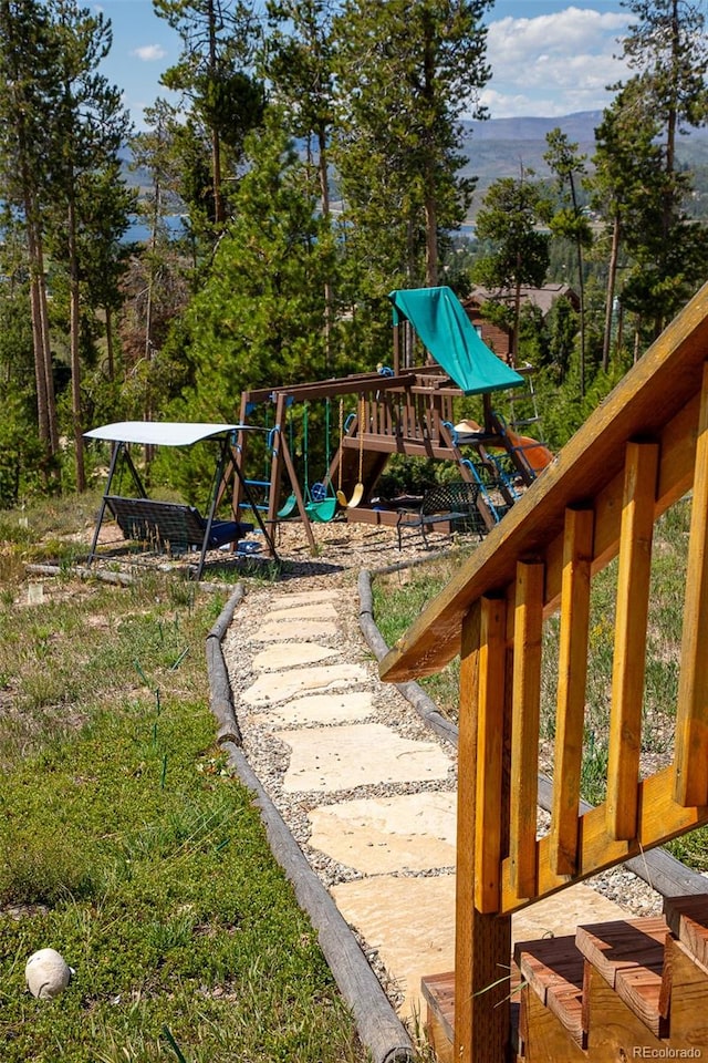 view of yard with a mountain view and a playground