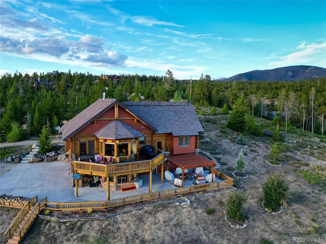 rear view of house featuring a gazebo, a patio area, and a deck with mountain view