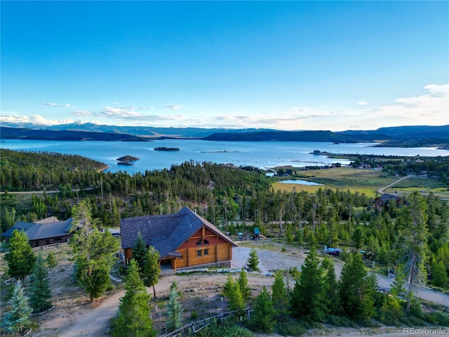 drone / aerial view with a water and mountain view