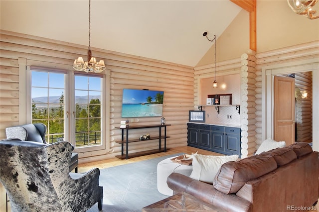 living room with log walls, wood-type flooring, high vaulted ceiling, and a chandelier