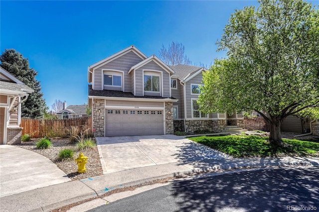 12646 S Dove Creek Way, Parker, CO 80134 - view of front facade with stone siding, concrete driveway, fence, and a garage