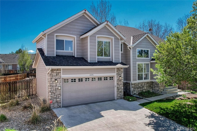 12646 S Dove Creek Way, Parker, CO 80134 - traditional-style home with stone siding, an attached garage, driveway, fence, and roof with shingles