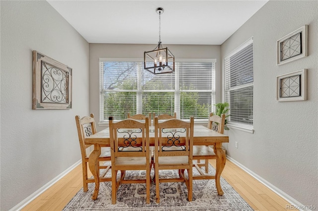 12646 S Dove Creek Way, Parker, CO 80134 - dining room with a chandelier, light wood-style flooring, baseboards, and a textured wall