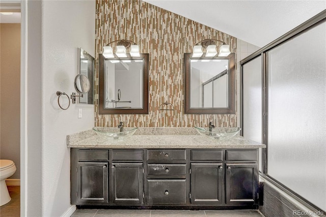 12646 S Dove Creek Way, Parker, CO 80134 - bathroom with a shower with door, double vanity, toilet, and baseboards