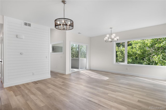 interior space with a wealth of natural light, visible vents, and a notable chandelier