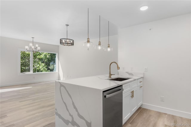 kitchen with a sink, white cabinets, stainless steel dishwasher, light stone countertops, and decorative light fixtures