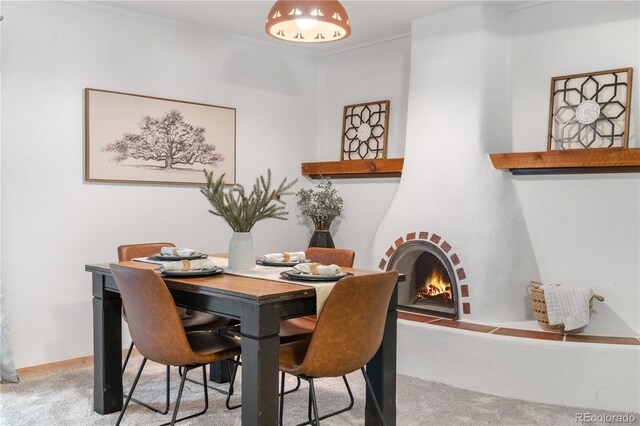 3700 Indianpipe Cir, Colorado Springs, CO 80918 - carpeted dining room with a brick fireplace and crown molding