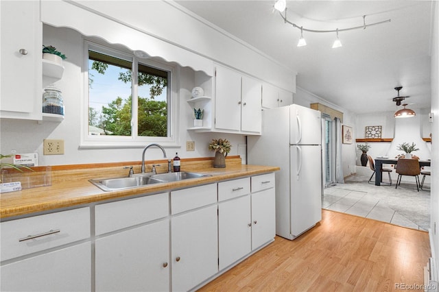 3700 Indianpipe Cir, Colorado Springs, CO 80918 - kitchen featuring open shelves, freestanding refrigerator, white cabinetry, light countertops, and light wood-type flooring