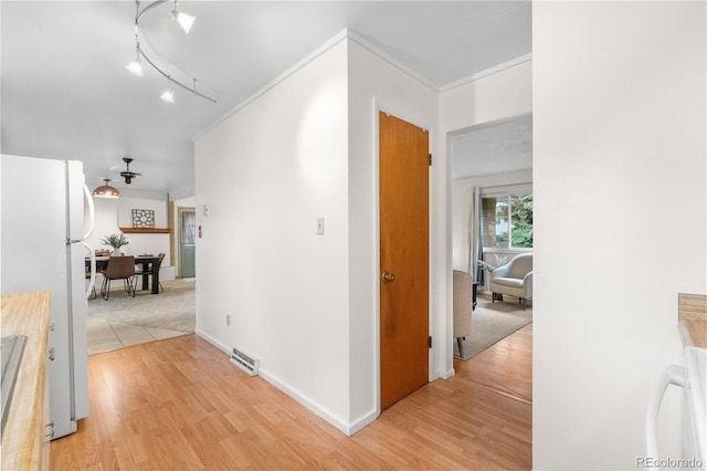 3700 Indianpipe Cir, Colorado Springs, CO 80918 - corridor featuring light wood-style flooring, ornamental molding, and track lighting