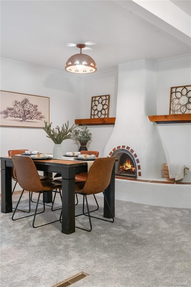 3700 Indianpipe Cir, Colorado Springs, CO 80918 - dining space with carpet floors and a warm lit fireplace