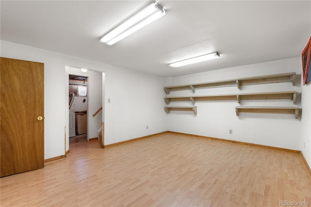 3700 Indianpipe Cir, Colorado Springs, CO 80918 - finished below grade area featuring light wood-type flooring, stairs, and washer / clothes dryer