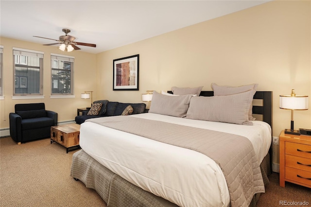 bedroom featuring ceiling fan, baseboard heating, and carpet