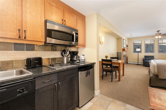 kitchen featuring light carpet, ceiling fan, tasteful backsplash, dark stone counters, and stainless steel appliances