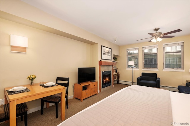 bedroom featuring ceiling fan, carpet, and baseboard heating