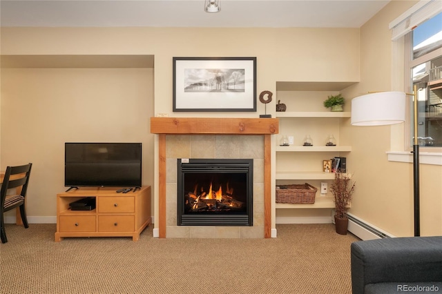 living room with built in shelves, baseboard heating, light carpet, and a tiled fireplace