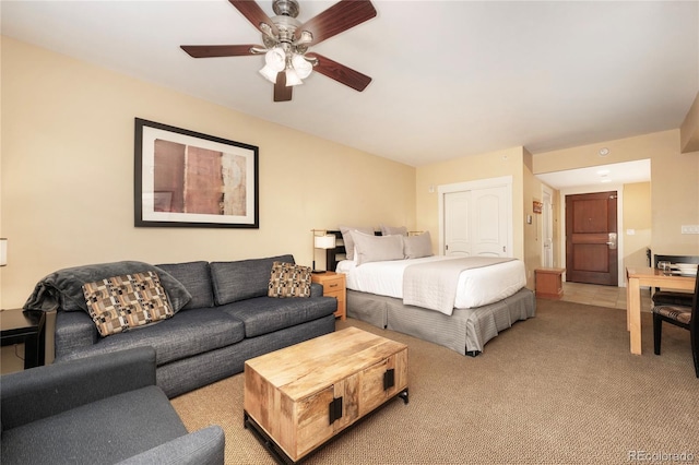 bedroom with light colored carpet and ceiling fan