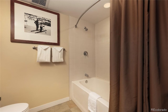 bathroom with toilet, tile patterned floors, and shower / tub combo with curtain