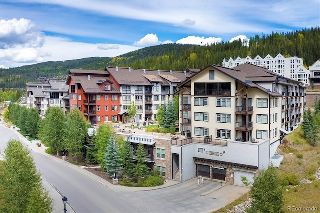 view of property featuring a garage and a mountain view