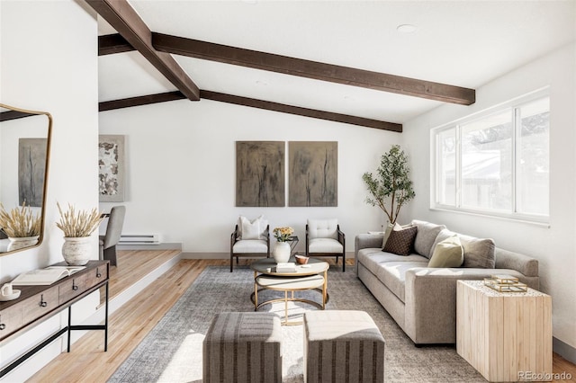 living room featuring light wood-type flooring, vaulted ceiling with beams, and a baseboard heating unit