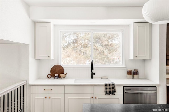 kitchen with sink, white cabinetry, and dishwasher