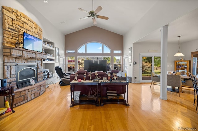 332 Battlement Creek Trl, Parachute, CO 81635 - living area with ceiling fan, wood finished floors, a stone fireplace, and high vaulted ceiling