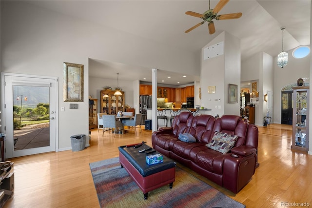 332 Battlement Creek Trl, Parachute, CO 81635 - living room with high vaulted ceiling, light wood finished floors, and a ceiling fan