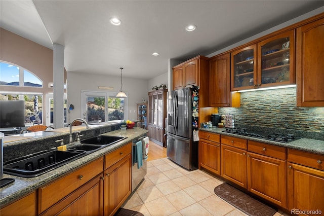 332 Battlement Creek Trl, Parachute, CO 81635 - kitchen with fridge with ice dispenser, black gas stovetop, dishwasher, brown cabinets, and recessed lighting