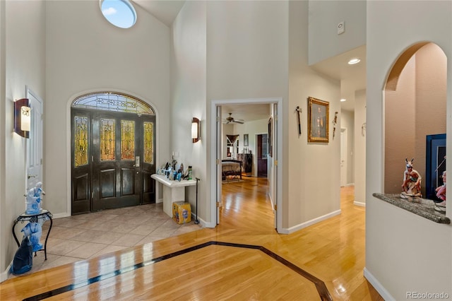 332 Battlement Creek Trl, Parachute, CO 81635 - entryway with a high ceiling, baseboards, arched walkways, wood finished floors, and a ceiling fan