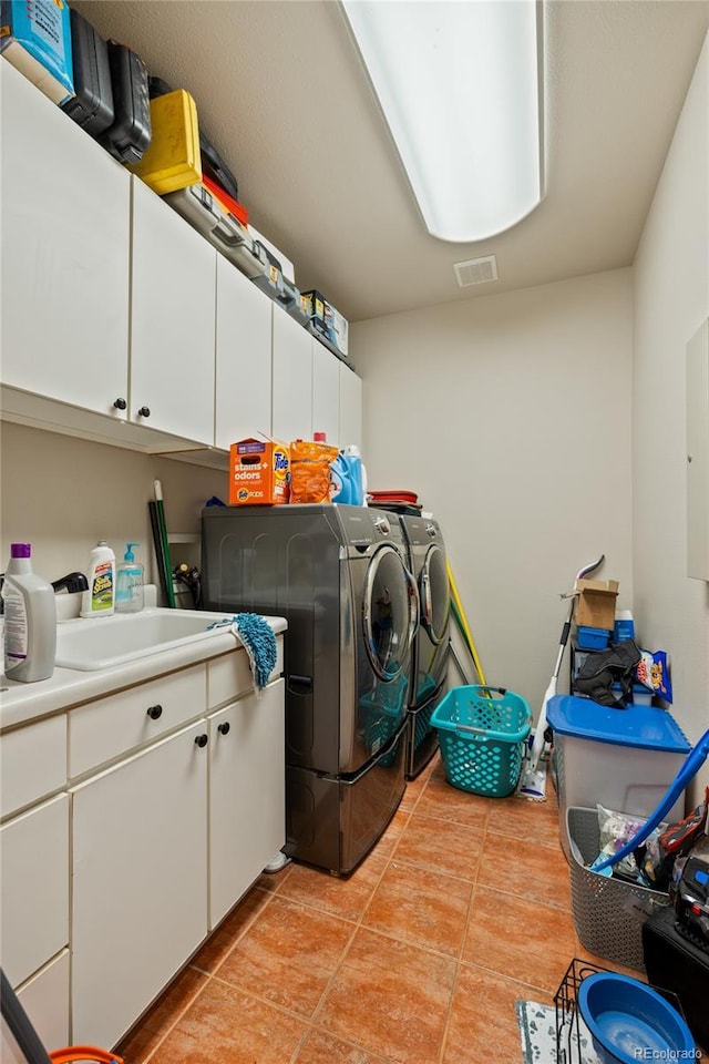 332 Battlement Creek Trl, Parachute, CO 81635 - washroom featuring separate washer and dryer, cabinet space, and light tile patterned floors