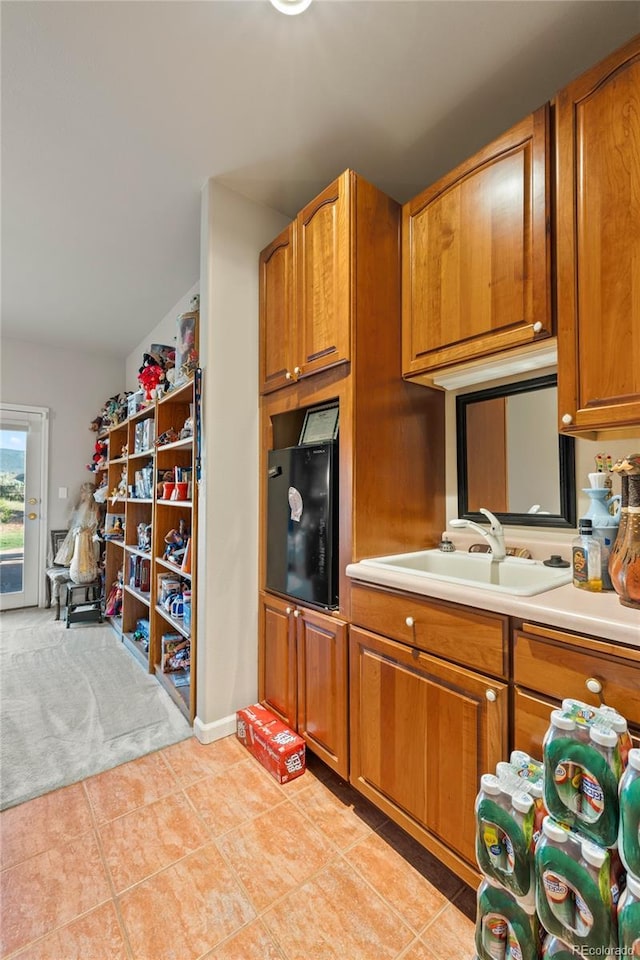 332 Battlement Creek Trl, Parachute, CO 81635 - kitchen with brown cabinets, light countertops, a sink, and light tile patterned flooring
