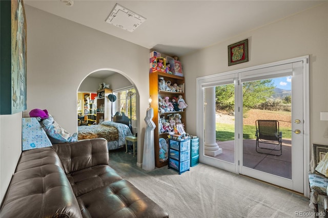 332 Battlement Creek Trl, Parachute, CO 81635 - carpeted living room with plenty of natural light and arched walkways