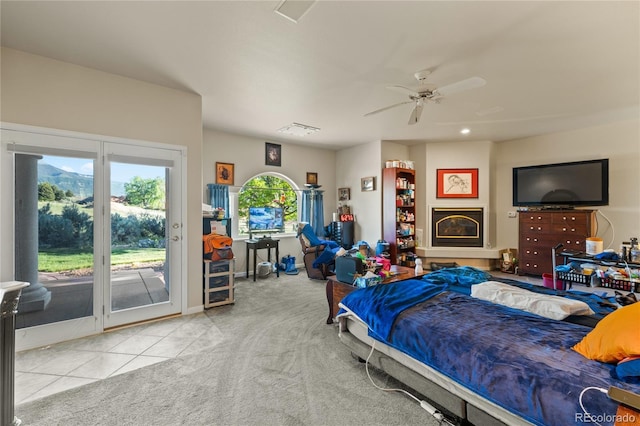 332 Battlement Creek Trl, Parachute, CO 81635 - carpeted bedroom with access to exterior, tile patterned flooring, and ceiling fan