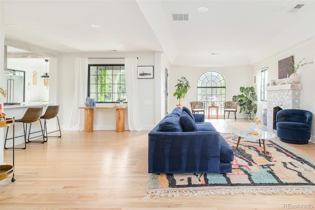 1300 N Glencoe St, Denver, CO 80220 - living room with healthy amount of natural light, wood finished floors, a fireplace, and recessed lighting