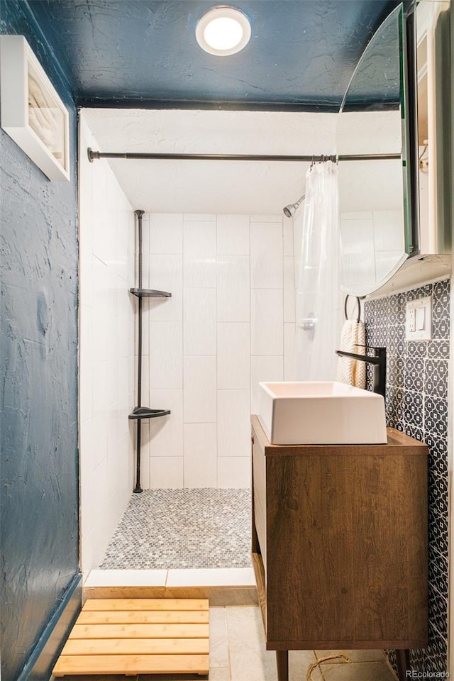 1300 N Glencoe St, Denver, CO 80220 - bathroom with a tile shower, vanity, and tile patterned floors