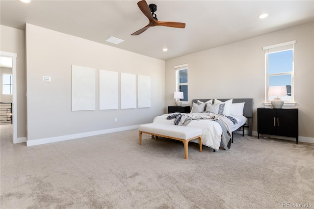 bedroom with multiple windows, light carpet, and ceiling fan