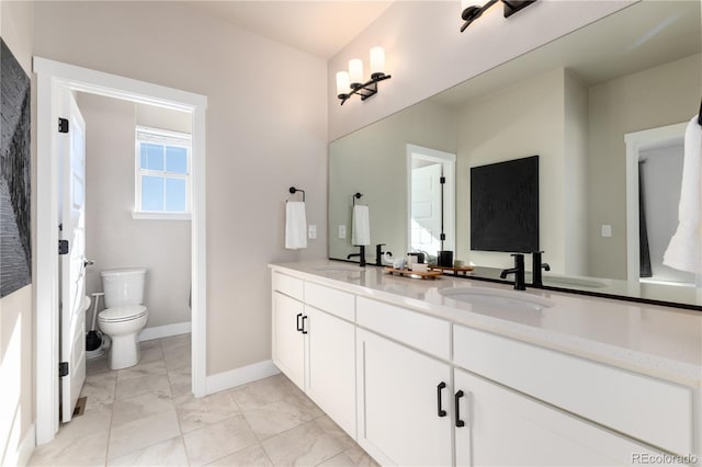 bathroom featuring vanity and toilet