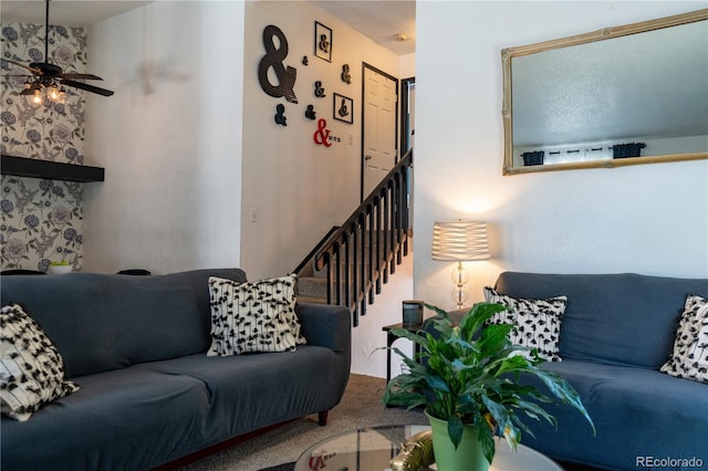 living area featuring carpet flooring and a ceiling fan